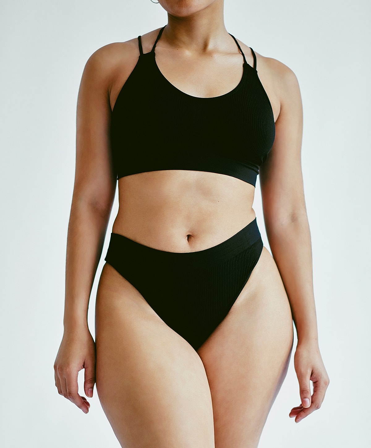 post weight loss body contouring patient model wearing stylish black bikini set.