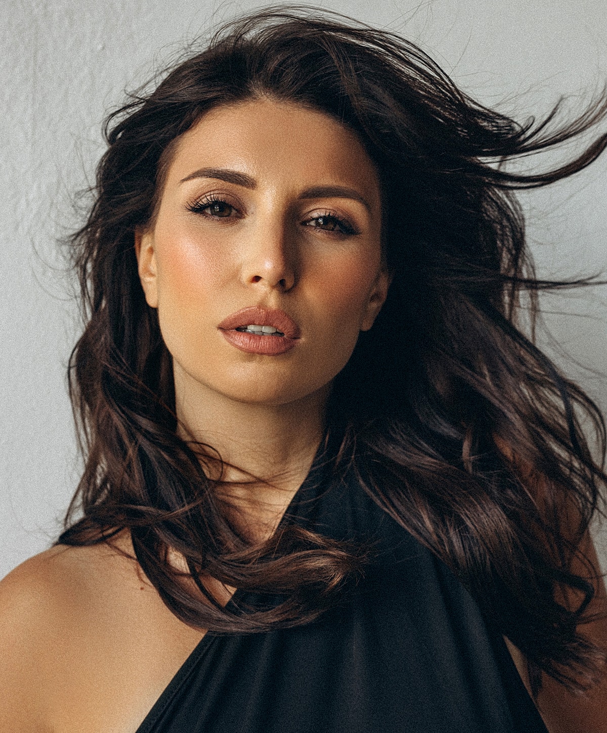 Woman with flowing hair and natural makeup.