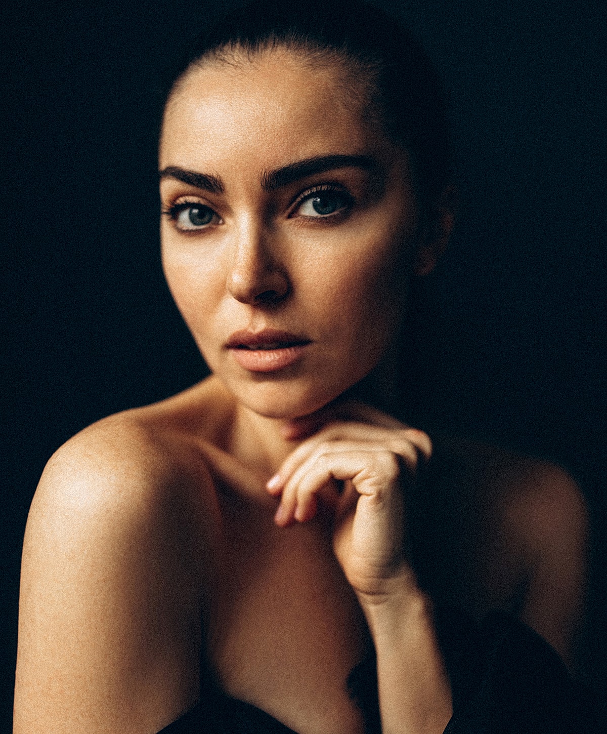 Portrait of an ultrasonic rhinoplasty patient model with thoughtful expression.