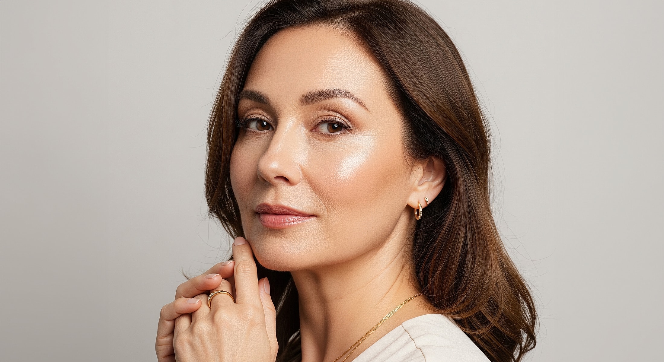 neck liposuction patient model with elegant makeup and light jewelry.