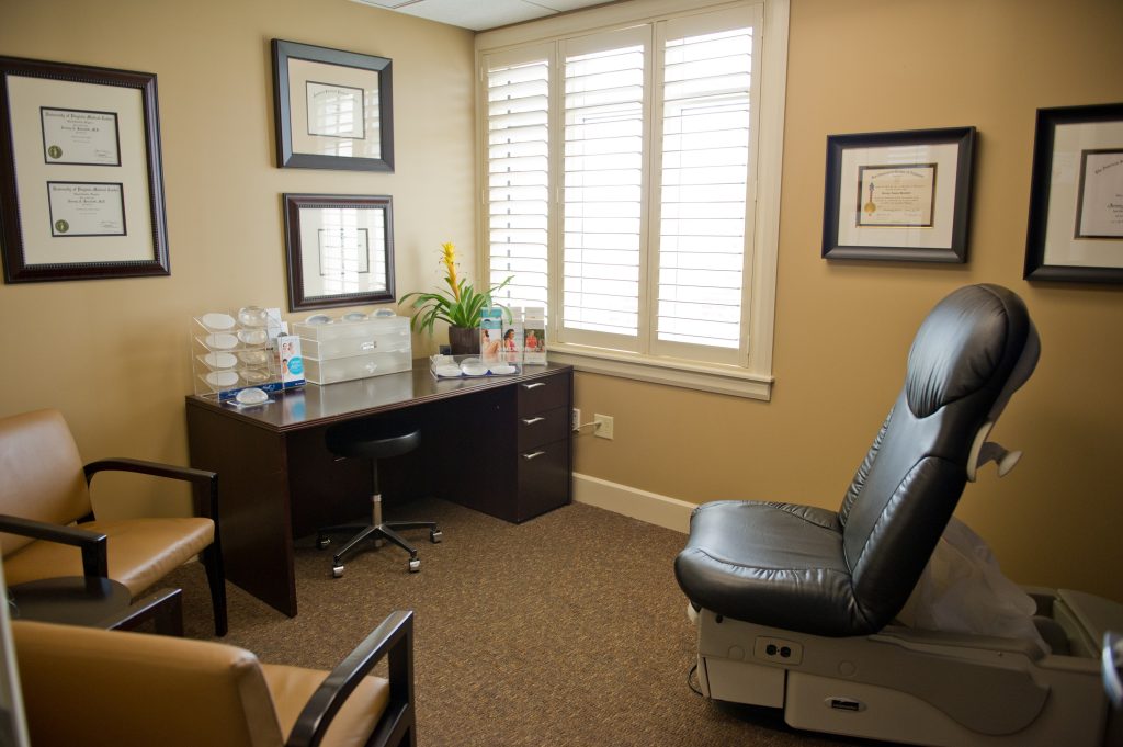 Consultation room waiting area with brown desk and medical recliner